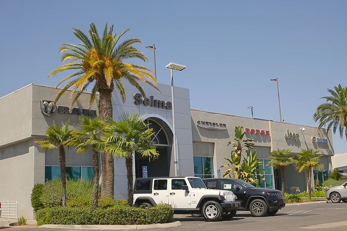 A car dealership building with 'Selma' on the front, and brand logos for Ram, Chrysler, Dodge, and Jeep.